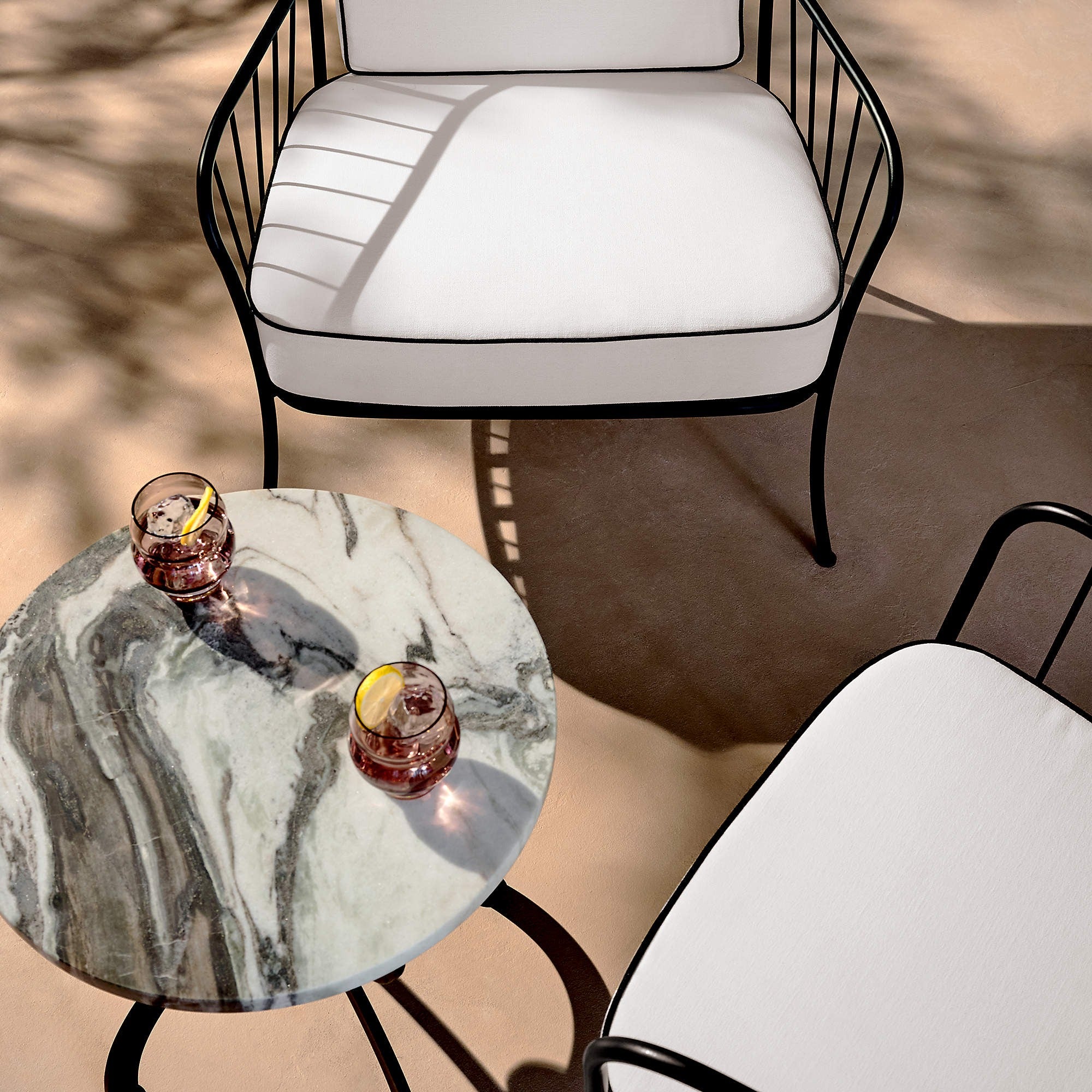 Welling Black Metal Outdoor Lounge Chair with White Cushions